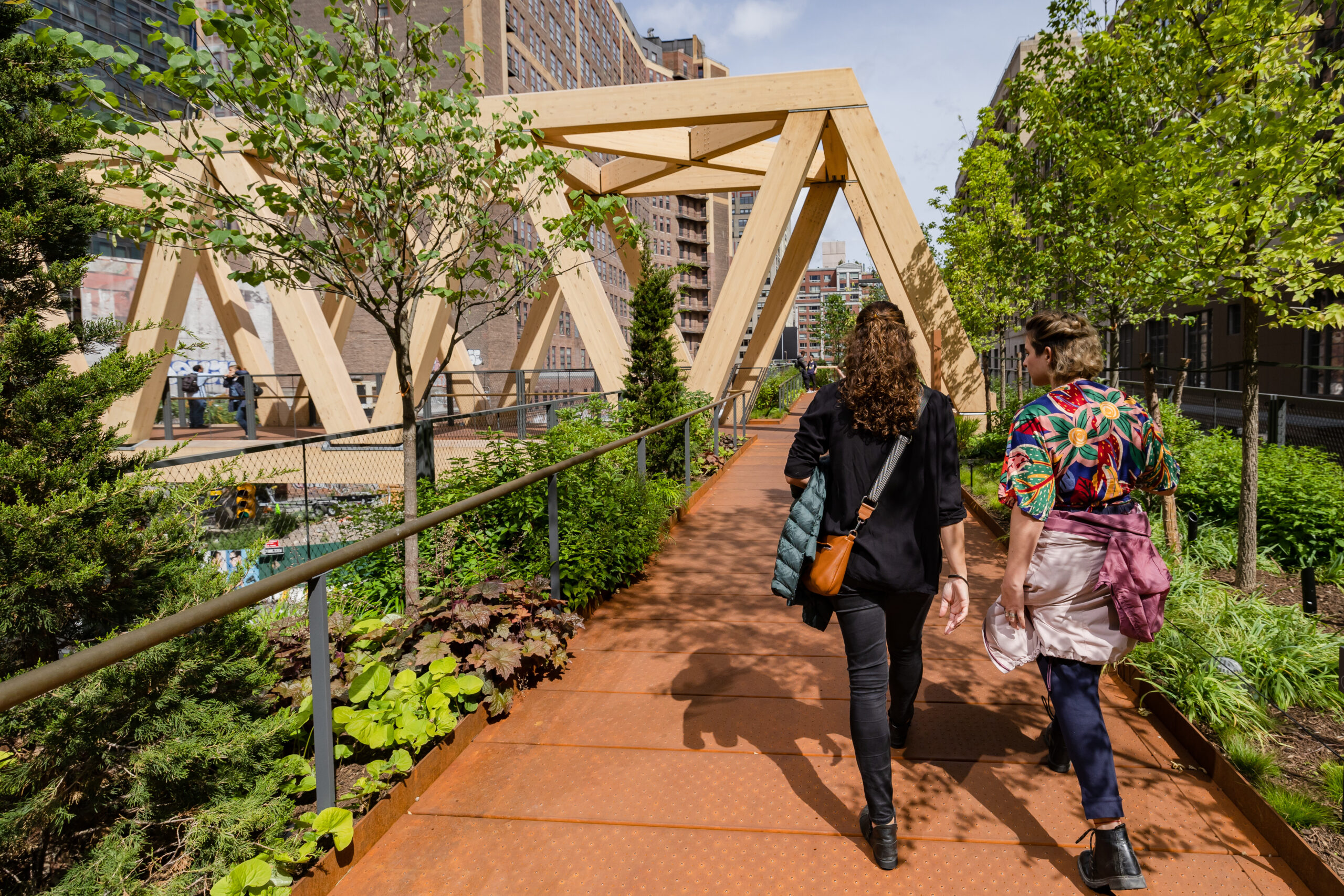 two people walk towards the Timber Bridge