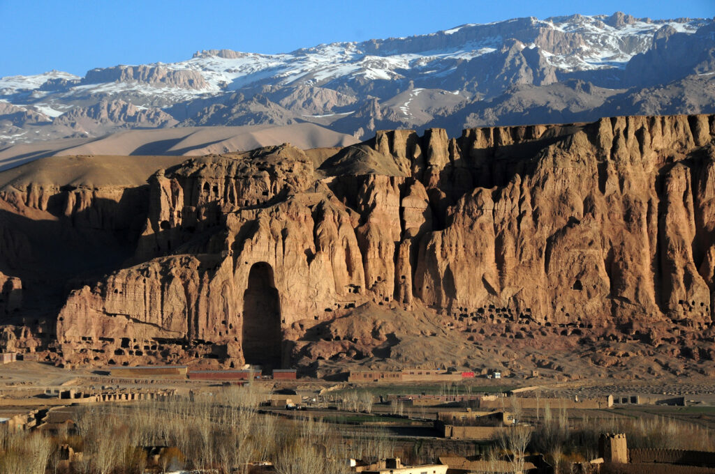As the sunrises over Afghanistan's Bamiyan Valley, the empty niche of a destroyed Buddha sculpture casts a long shadow.